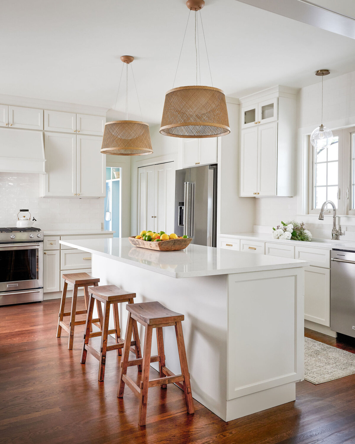 cocoloba homes cockrell ave kitchen with white island and wooden barstools