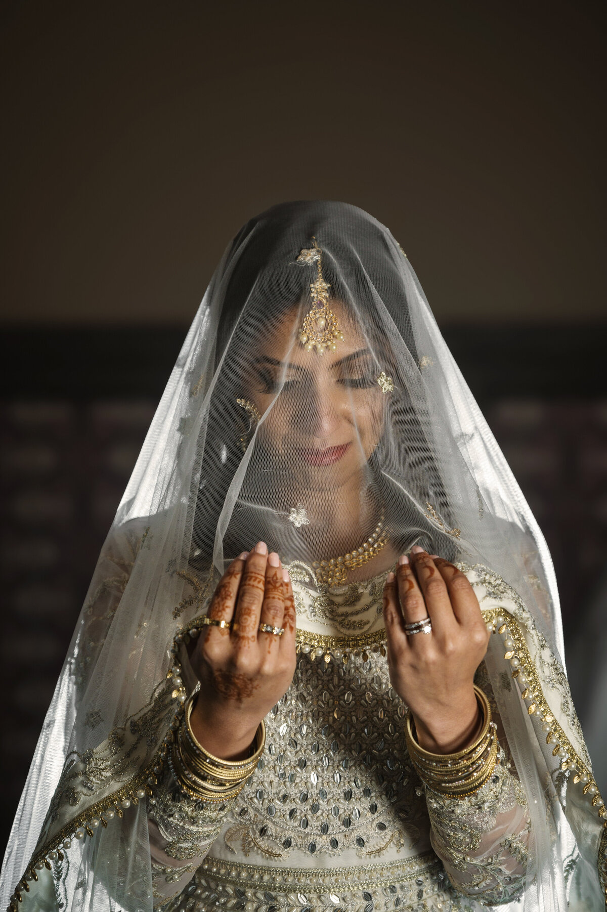 Bride posing showing wedding jewelry