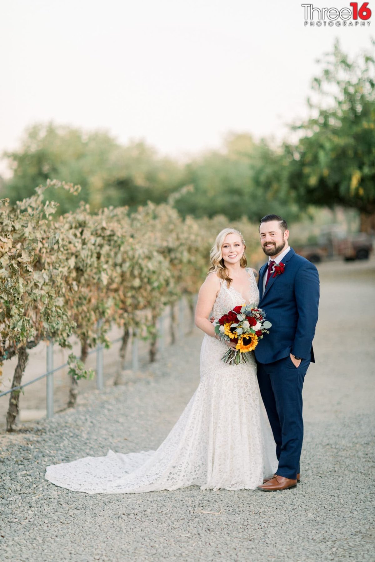 Bride and Groom pose together amongst the winery's bushes at the Peltzer Winery wedding venue