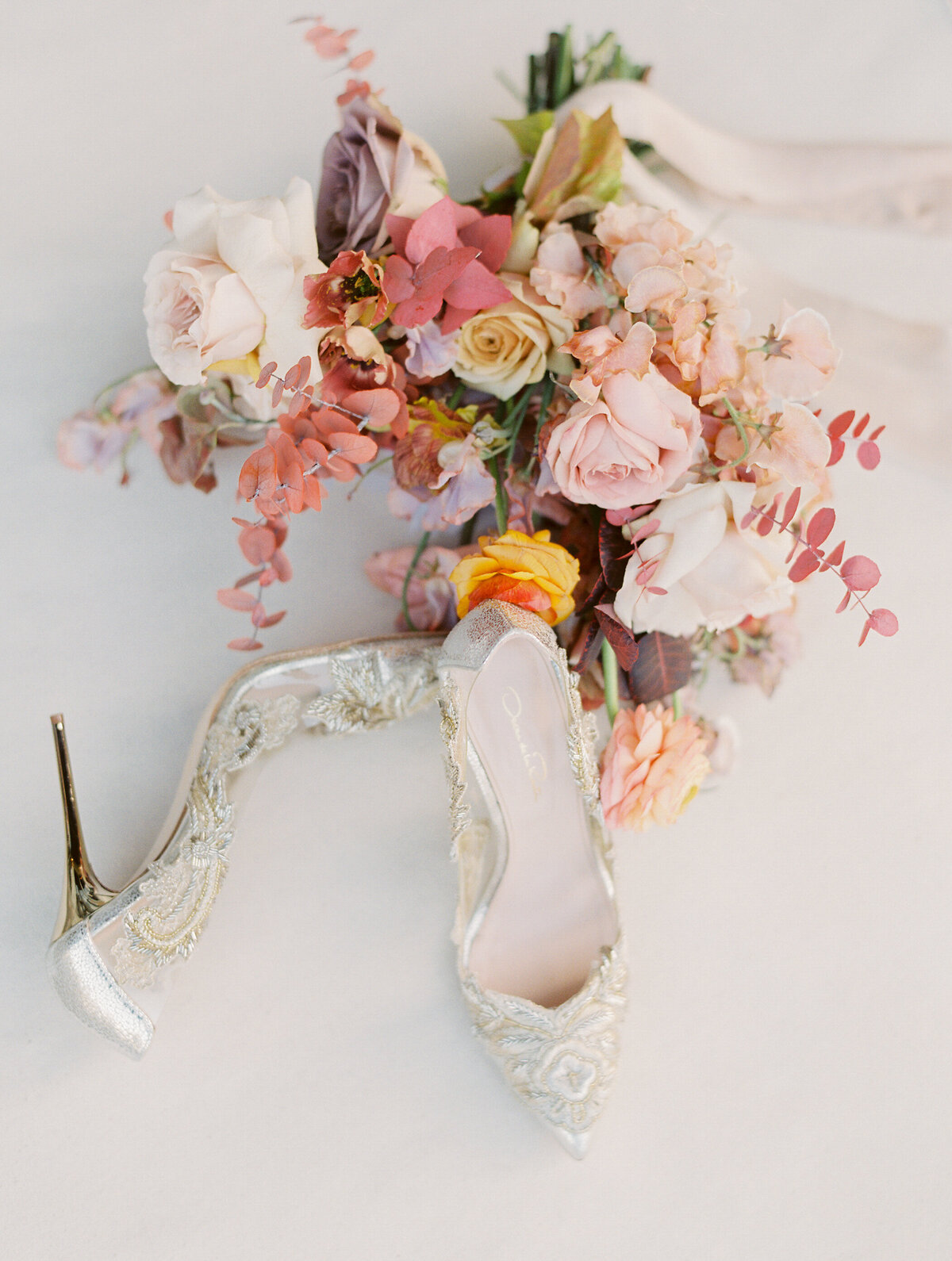 wedding bouquet and golden laced wedding shoes