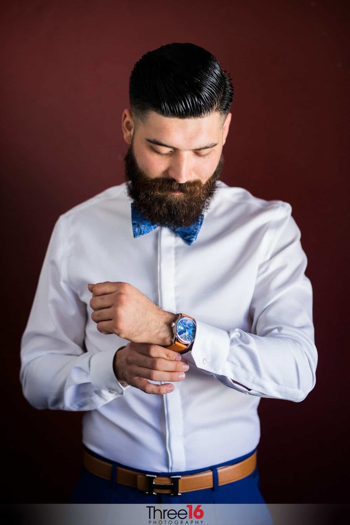 Groom puts on his watch as he gets ready for the ceremony