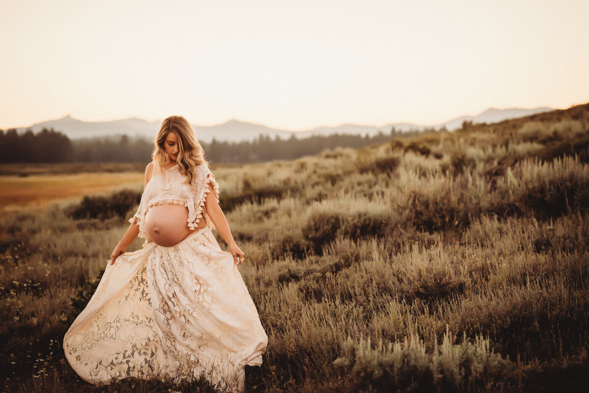Maternity session with mama to be wearing a two piece gown in a beautiful outdoor location