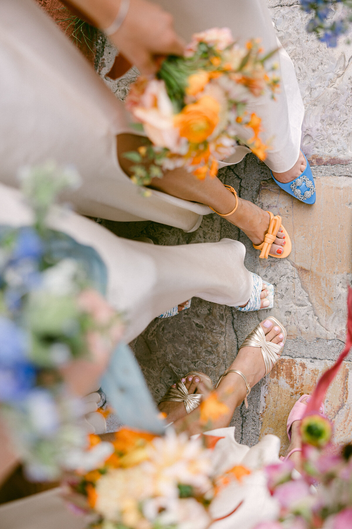 Vibrant bridesmaids style with color coordinating shoes and bouquets
