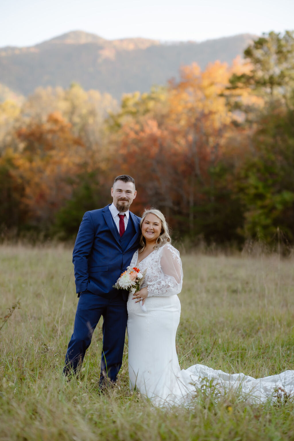 Couple eloping to Gatlinburg poses for wedding portraits by photographers in gatlinburg tn in Cades Cove at sunset  