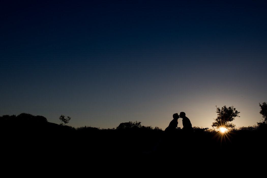Sunset wedding photo of couple kissing at The Green Weddings in Cornwall