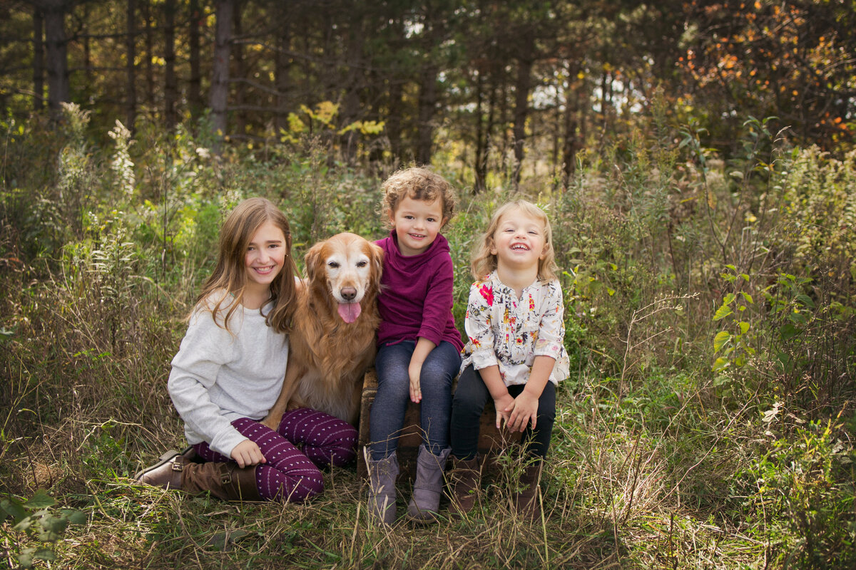 3 girls with dog in nature