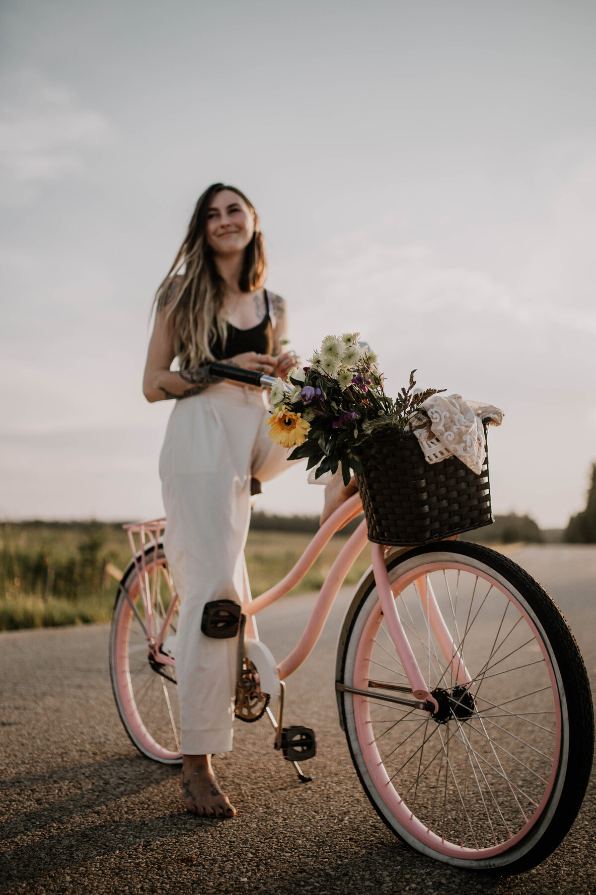 creative photography on a pink bicycle with flowers in the basket at golden hour photographer Stephanie Kristine Photography