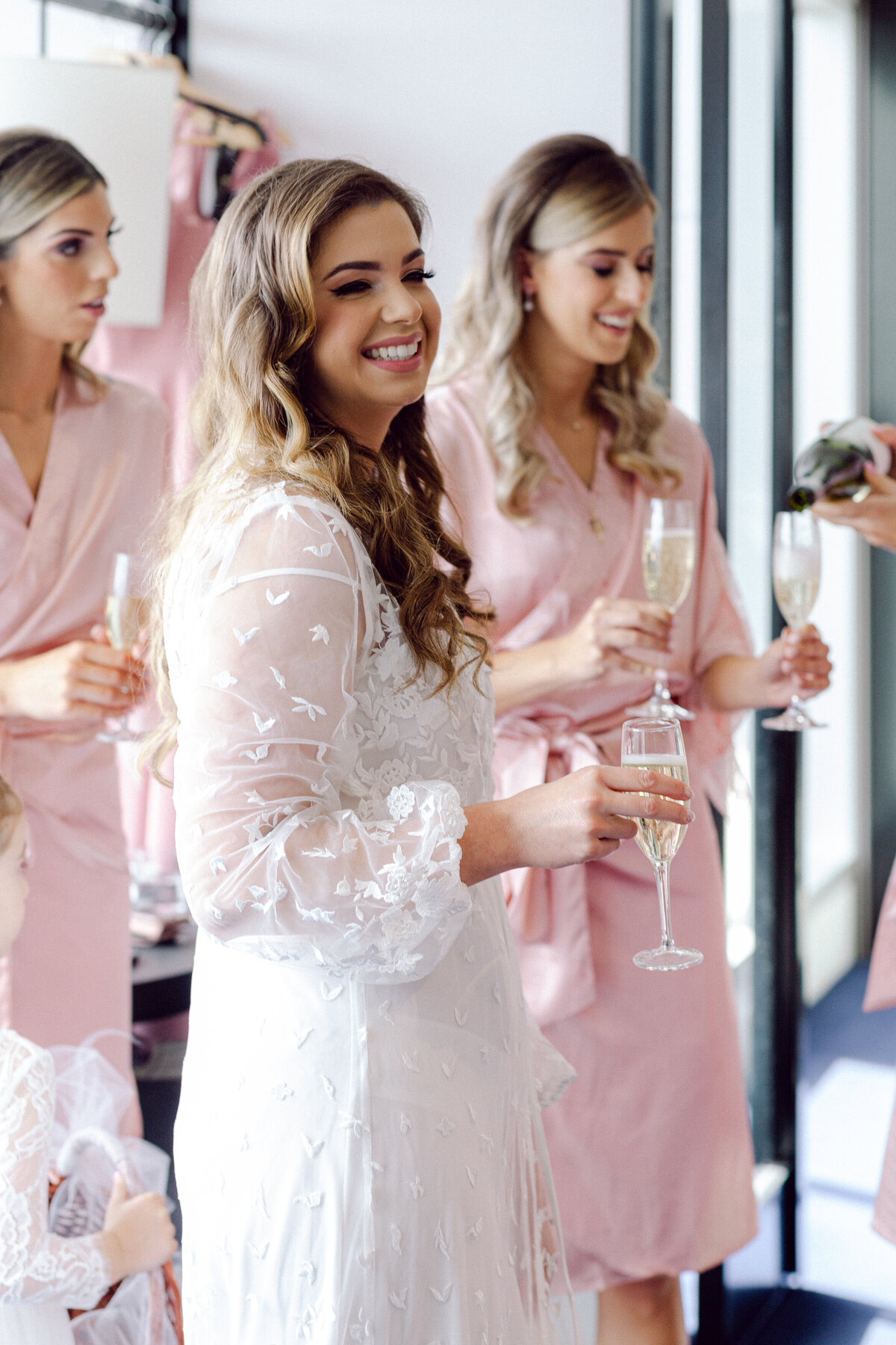 Bride in lace robe + Bridesmaids + Champagne and wine glasses