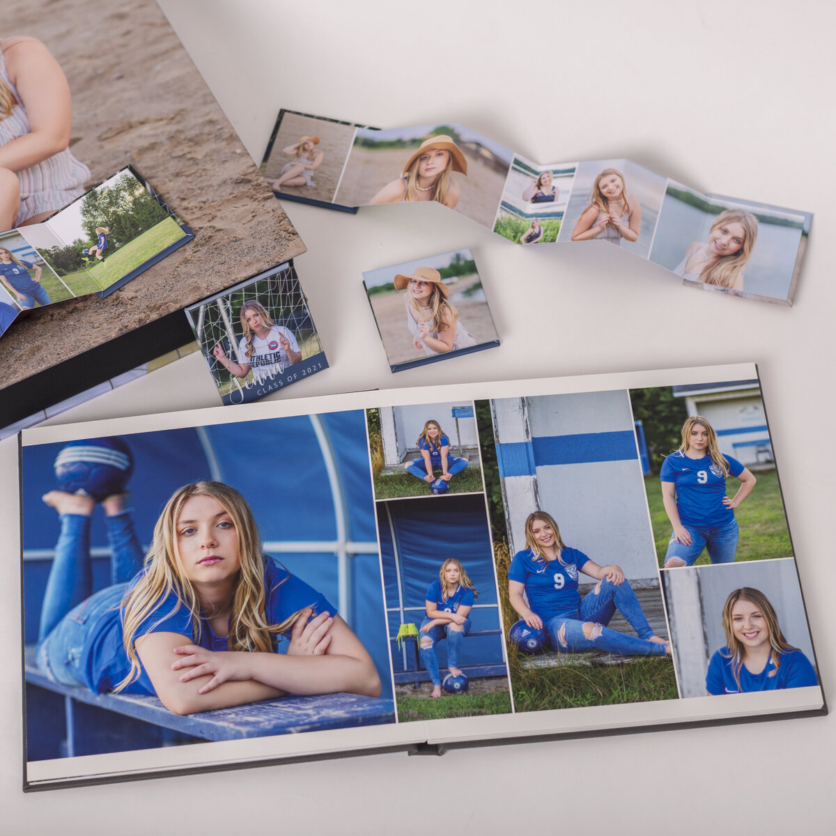flatlay of an album and mini books with senior girl with soccer senior portraits