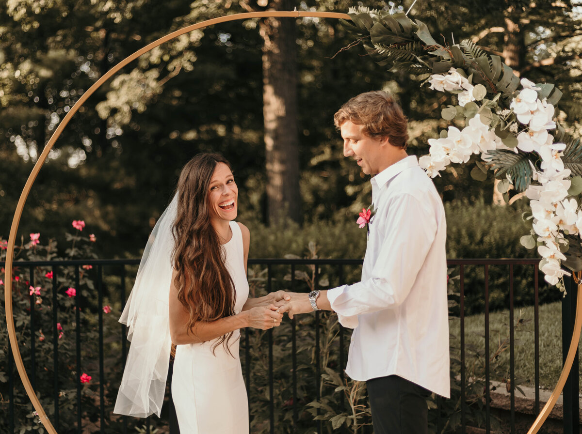 groom and bride exchanging rings for backyard elopement