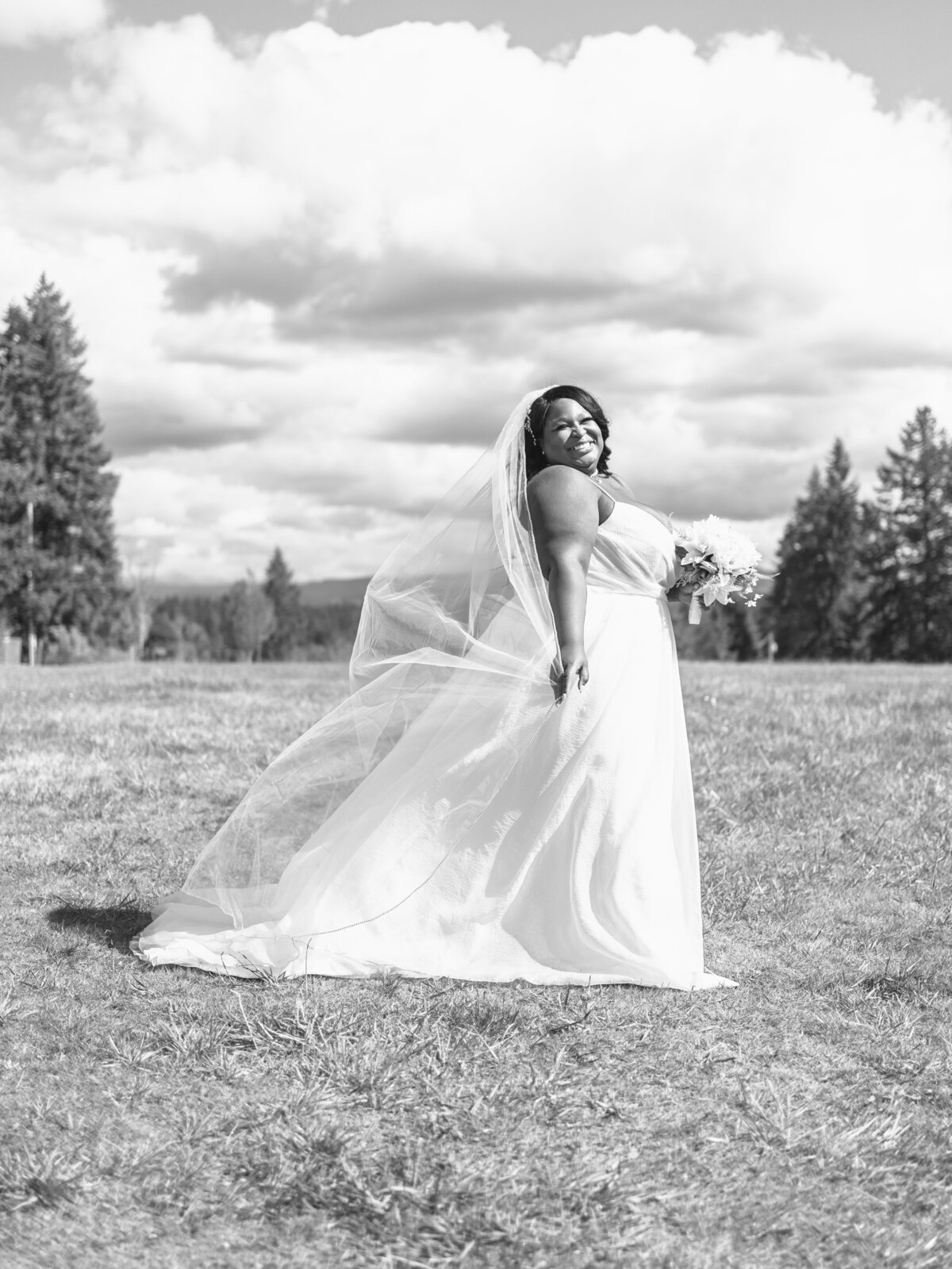A black and white photo of a bride in a cloudy day in SF