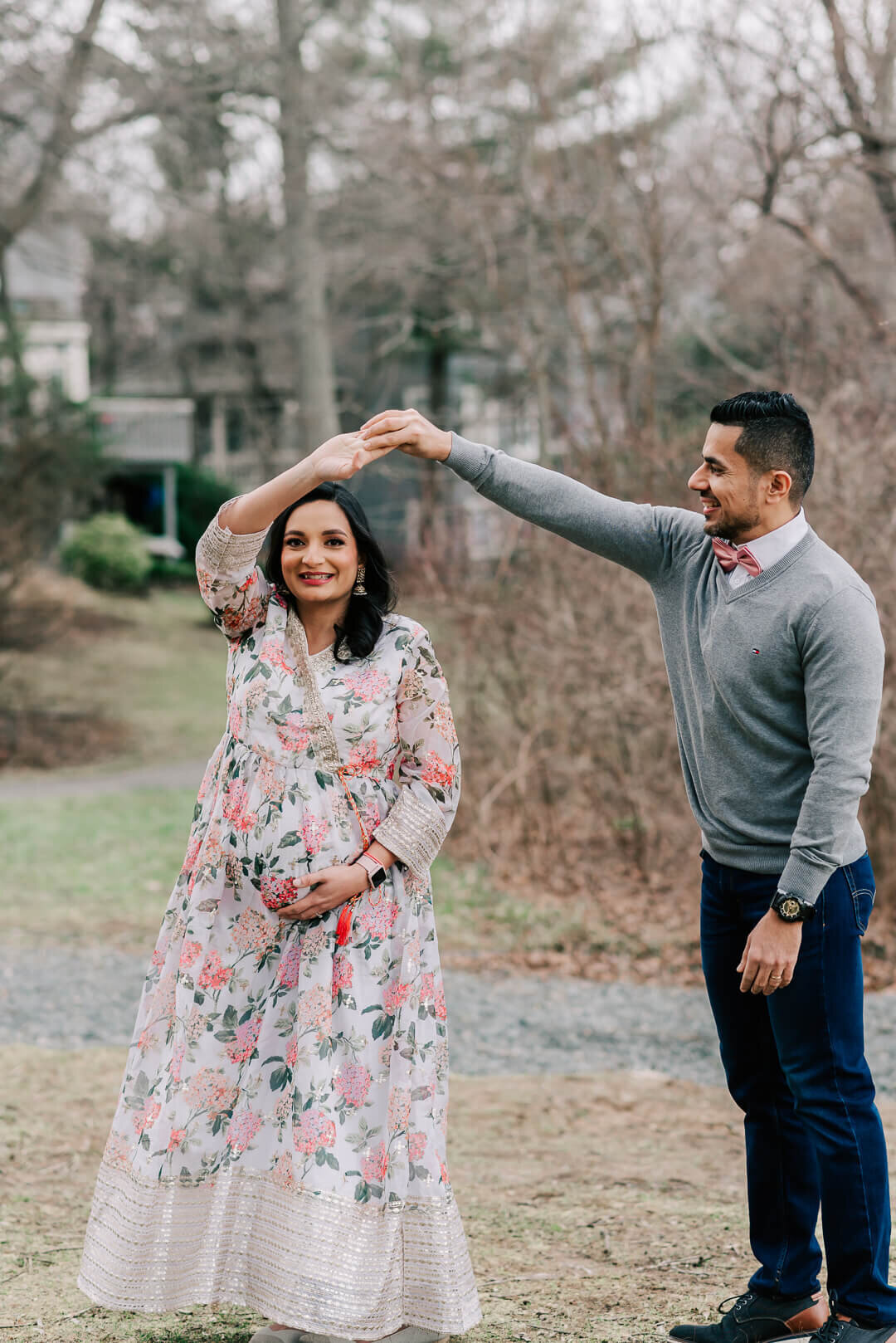 A couple enjoying  taking maternity photos at their baby shower, taken by northern virginia maternity photographer