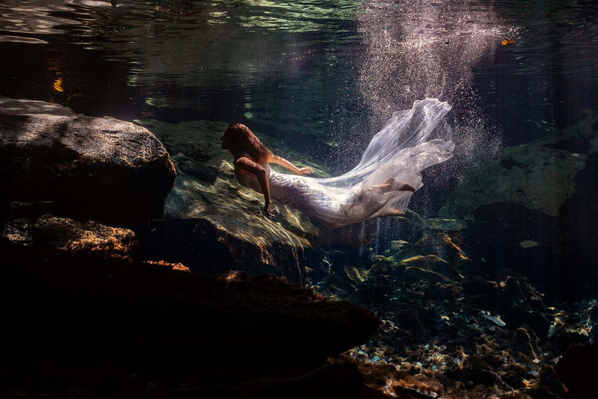Bride swimming underwater during TTD in Riviera maya