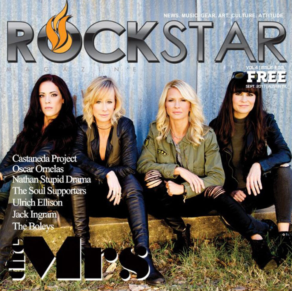 Magazine Cover Publication Rockstar featuring female band The Mrs sitting on low wood bench against corrugated metal background