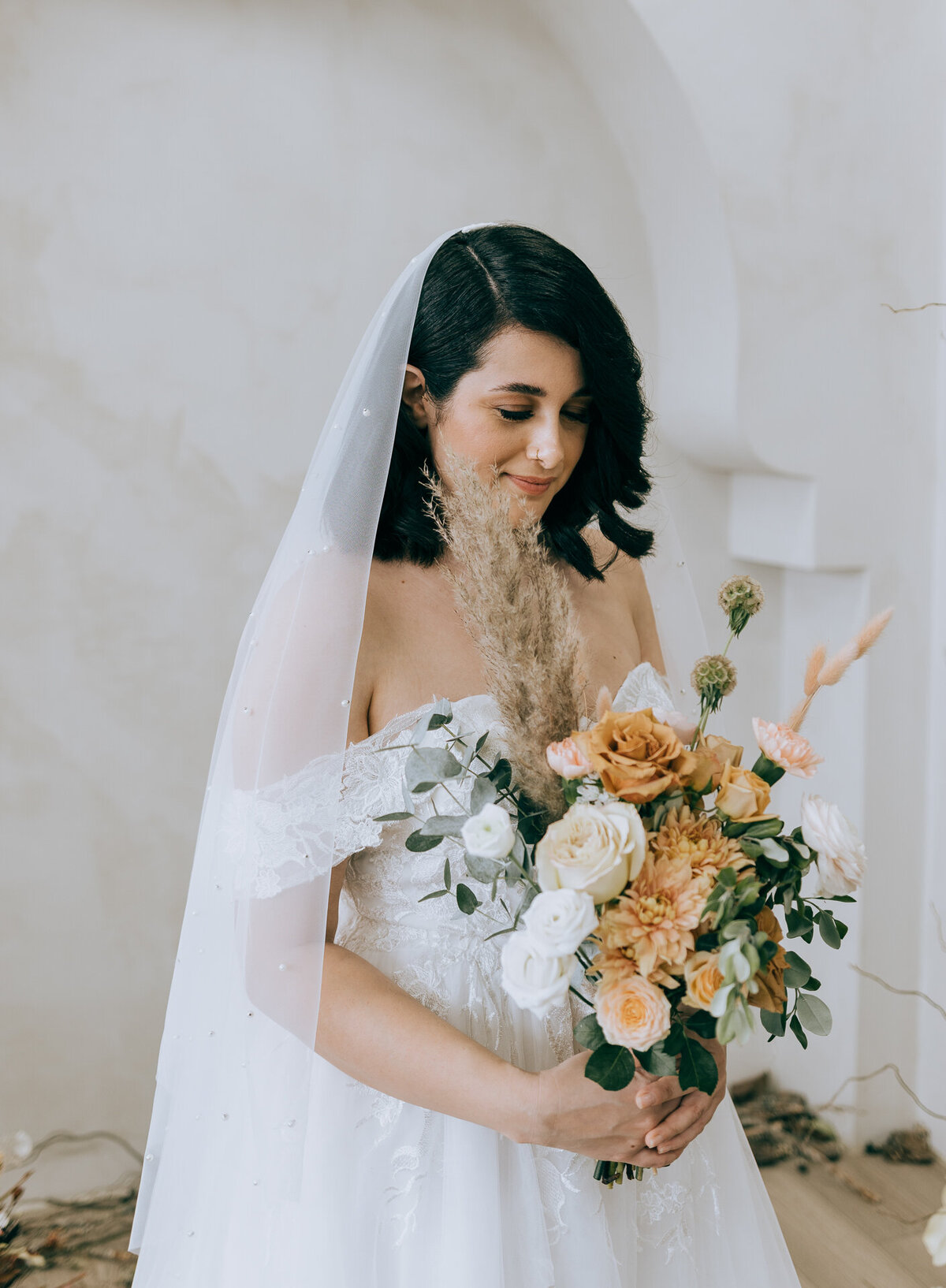 Bride in a white dress holding a bouquet of flowers.