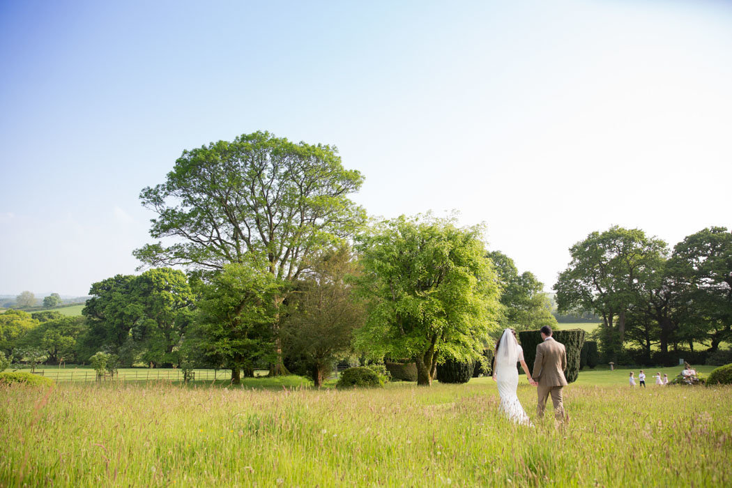 Coombe Trenchard Wedding couple walking on Dartmoor on their wedding day