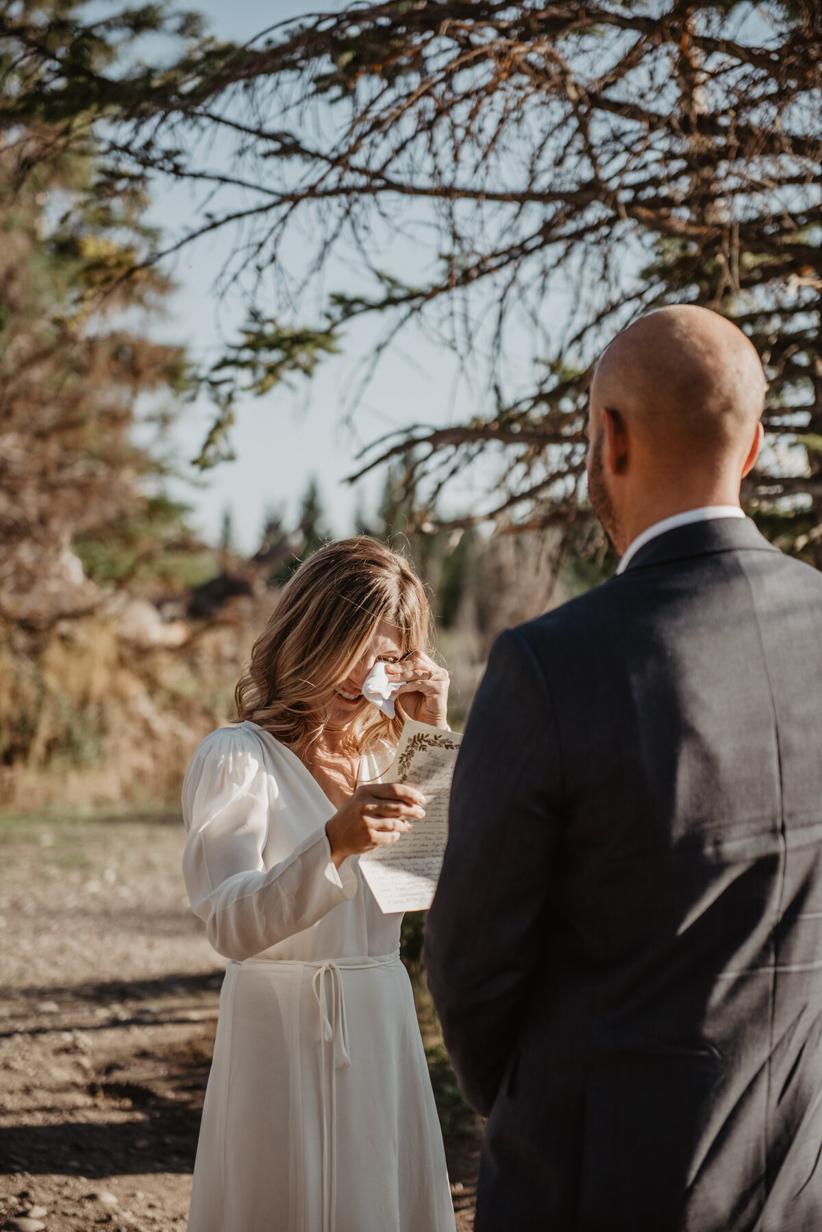jackson wyoming photographer captures jackson hole wedding with Bride saying her vows and wiping away tears during her Teton elopement