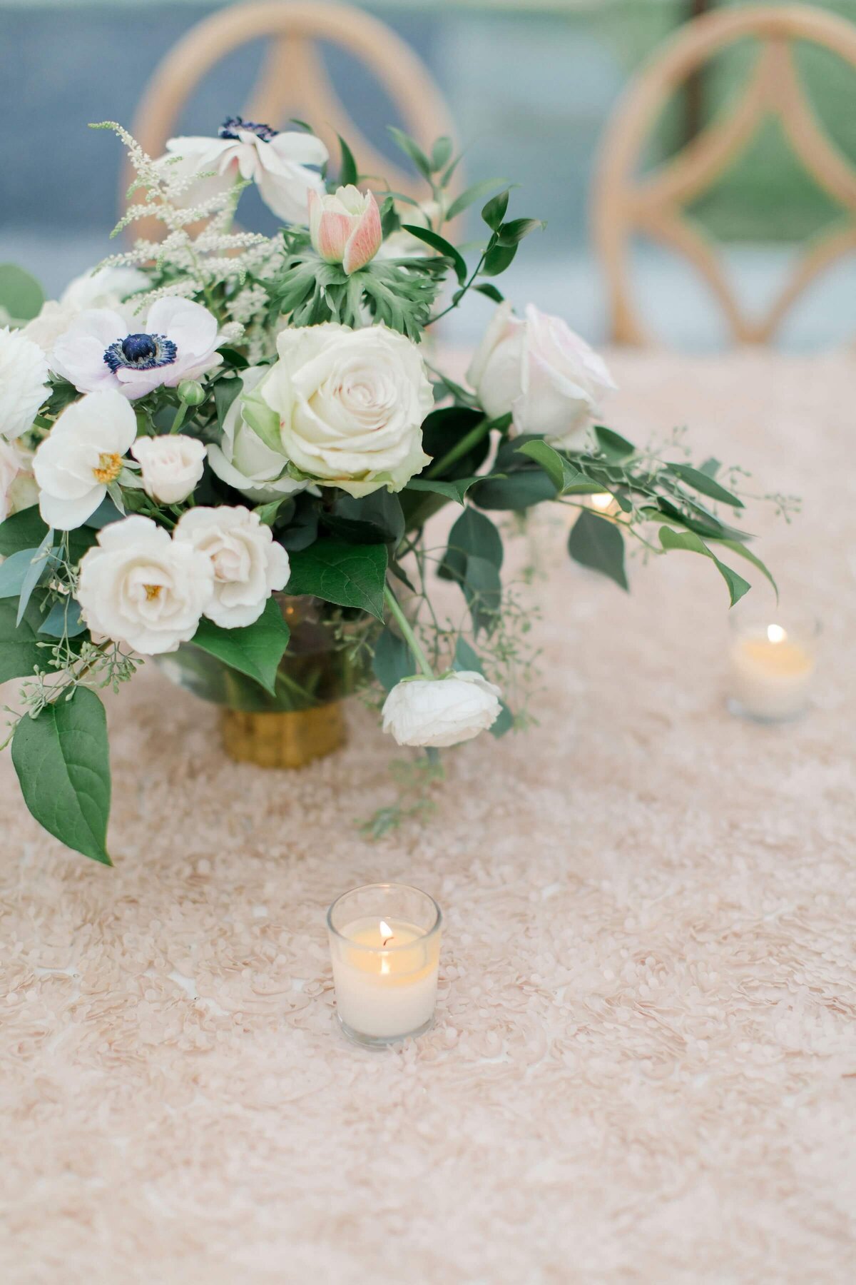 white floral centrepiece on gold tablecloth