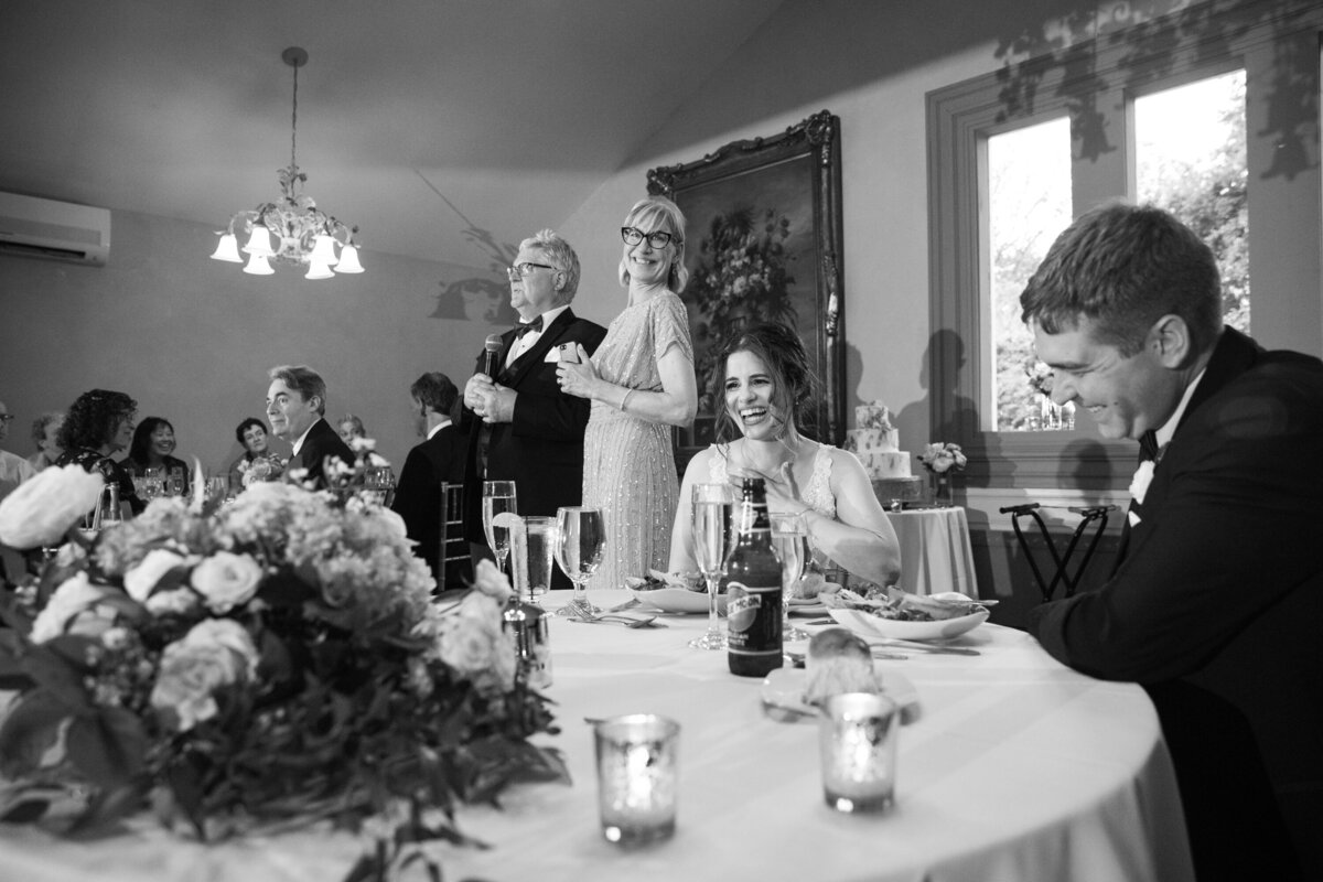 Black and white photo of parents of groom giving a toast Hudson Valley New York wedding photographer Milestone Images