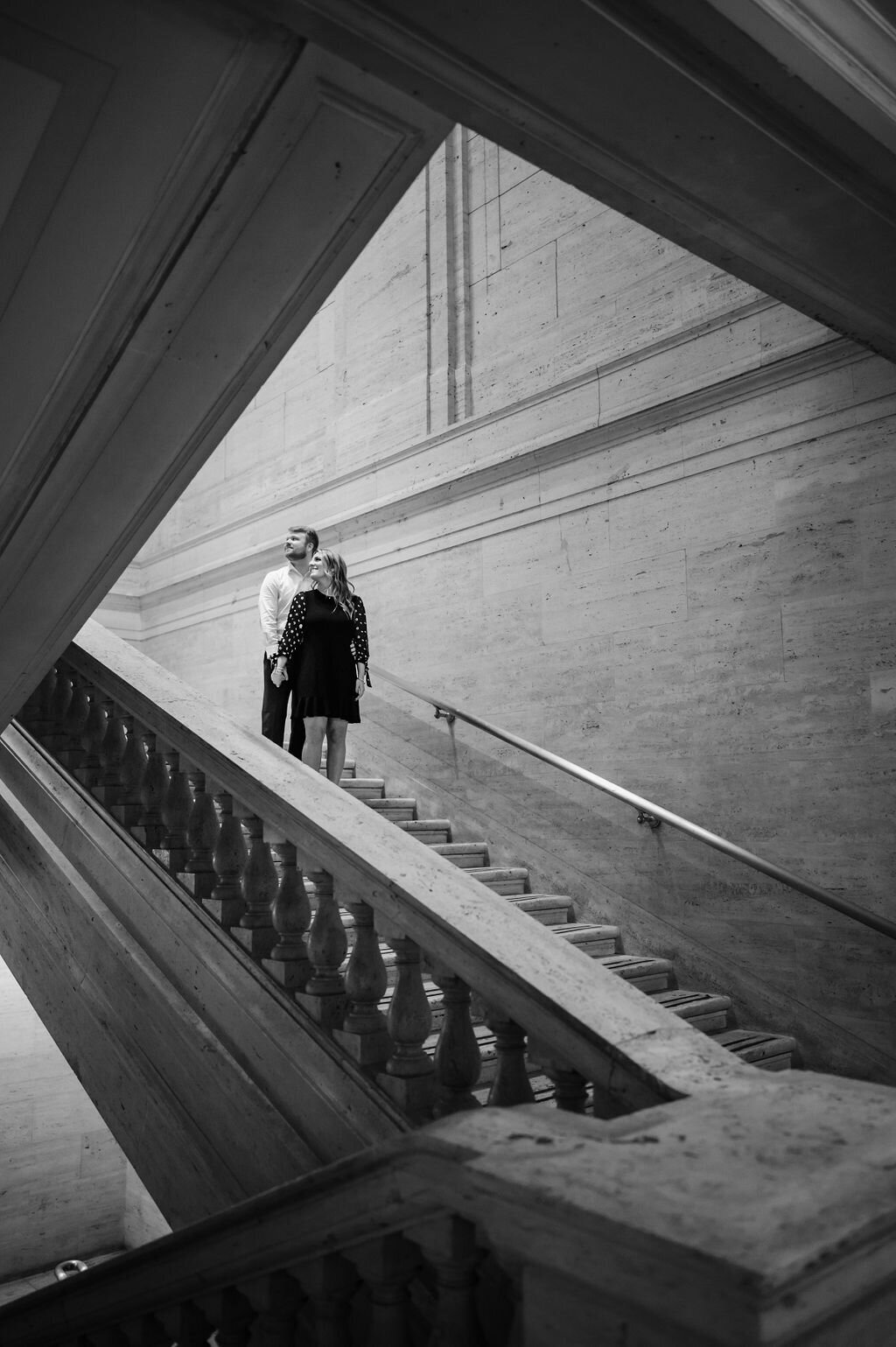 A couple stands in the stairwell at Chicago Union Station