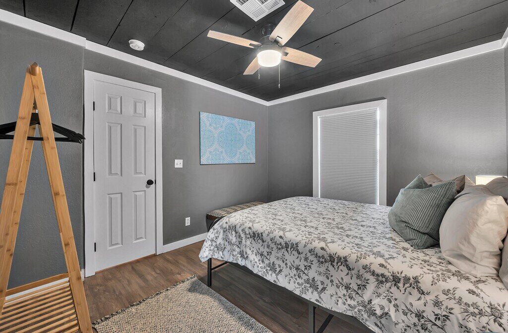 Bedroom with Queen bed at this two-bedroom, one-bathroom vacation rental house for five located just 5 minutes from Magnolia, Baylor, and all things downtown Waco.