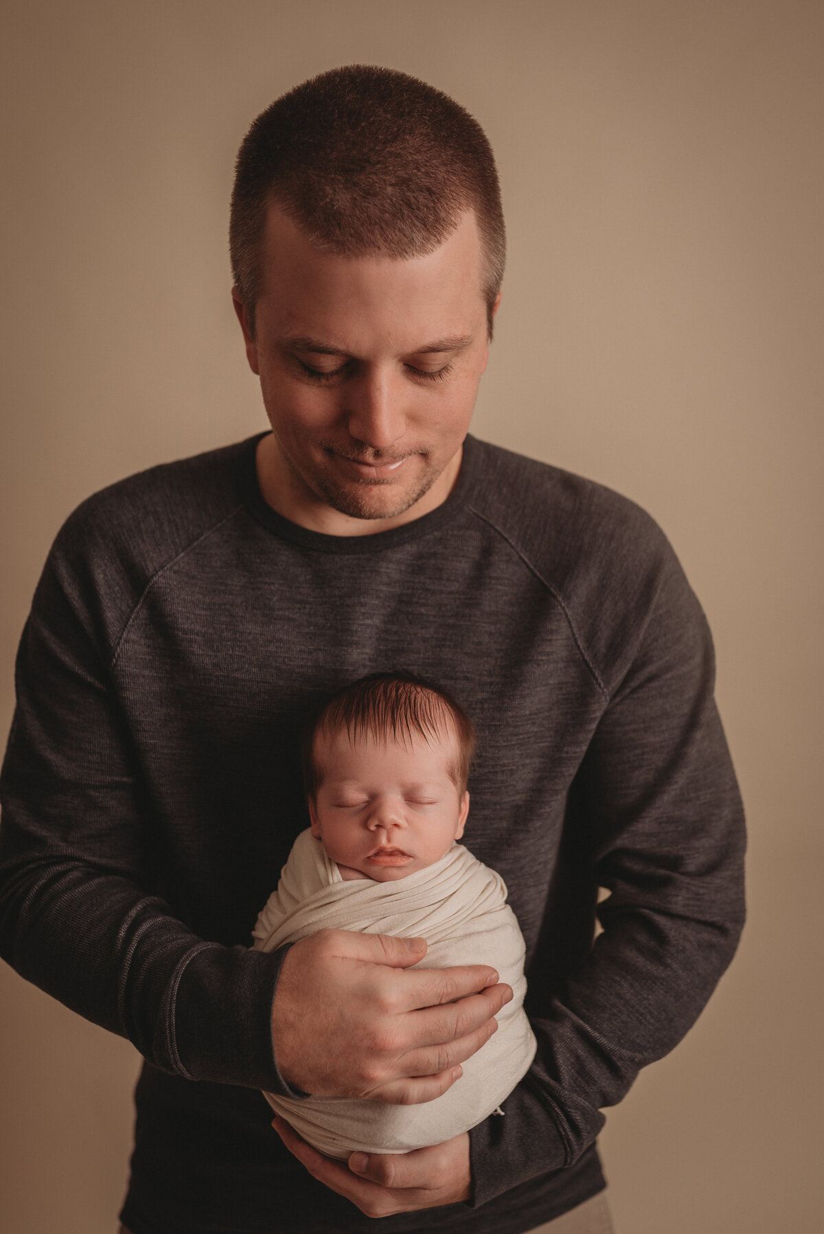 dad posing with newborn son for atlanta newborn photographer