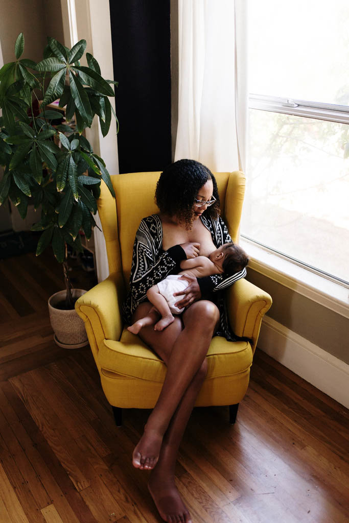 in home photography of breastfeeding  mom and baby during intimate motherhood session