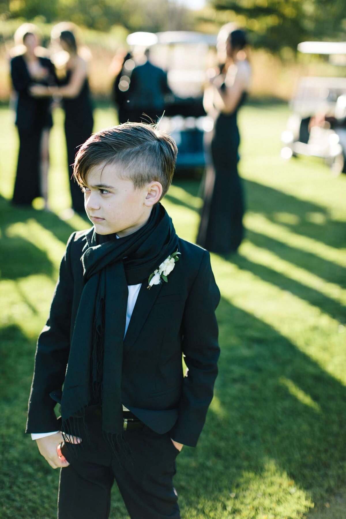 Ring Bearer dressed in Black Tie for a Fall Luxury Michigan Lakefront Golf Club Wedding.