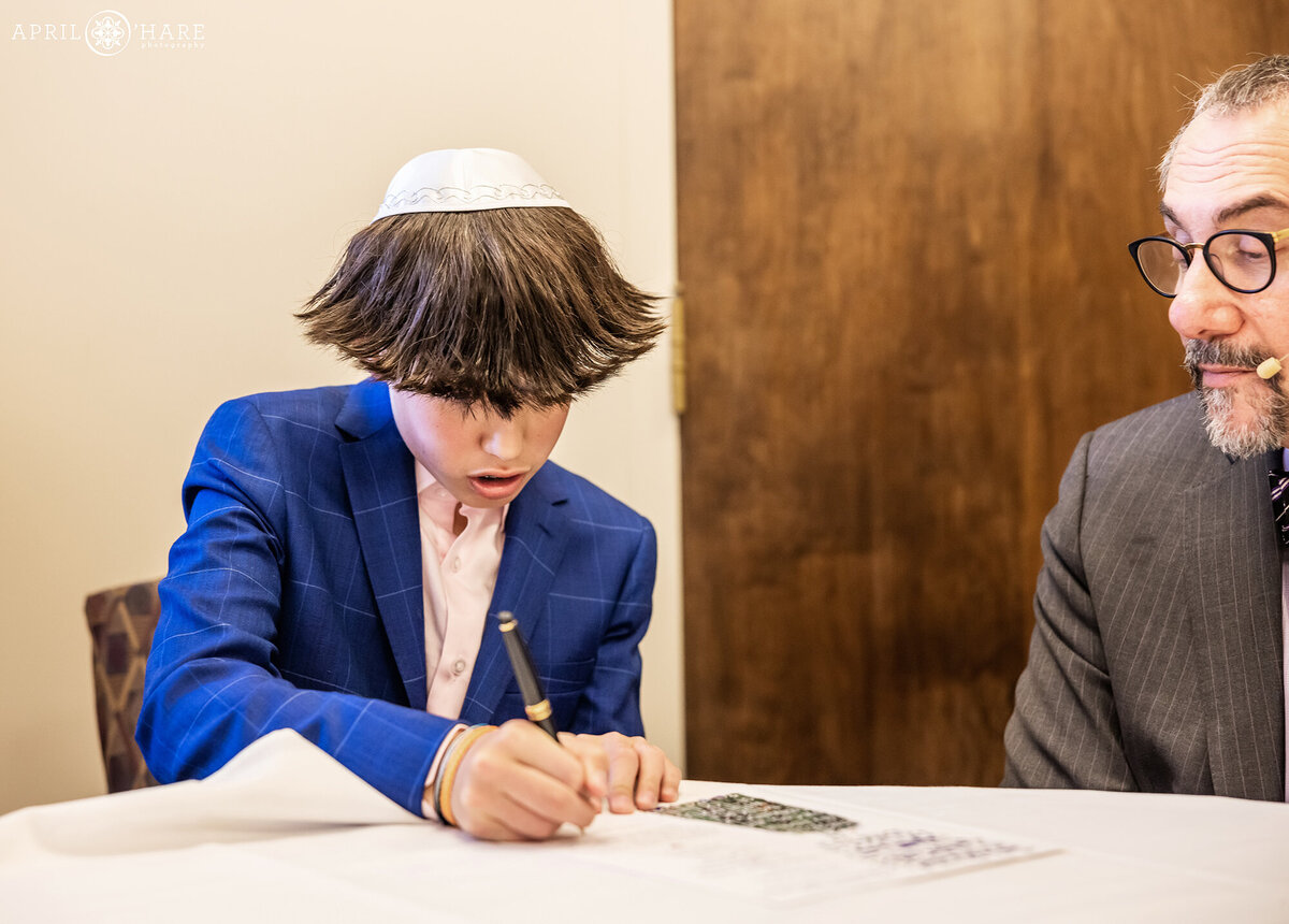 Young Man Signs his Bar Mitzvah Contract at Temple Emanuel in Denver Colorado