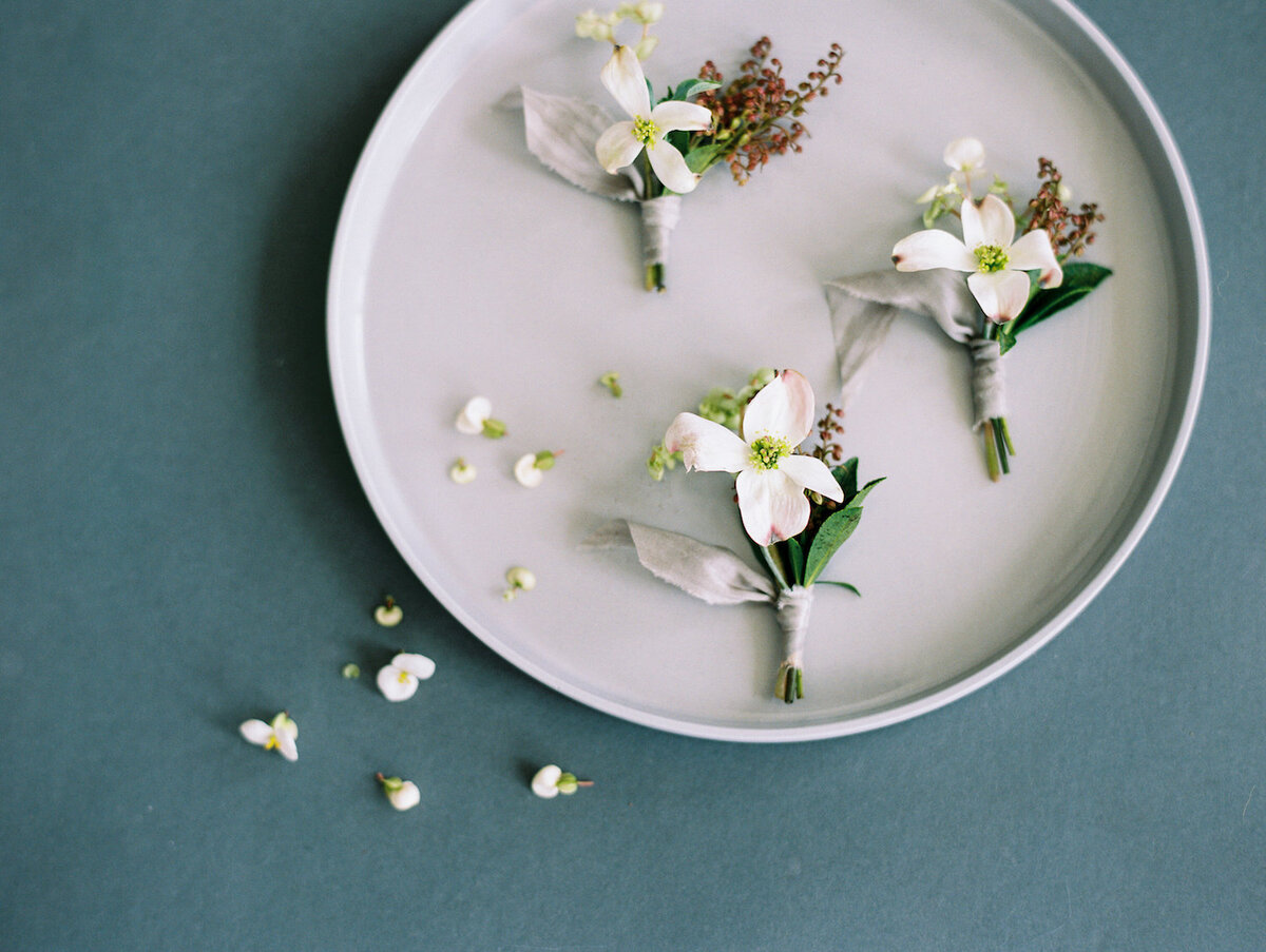 plate of delicate dogwood boutineers