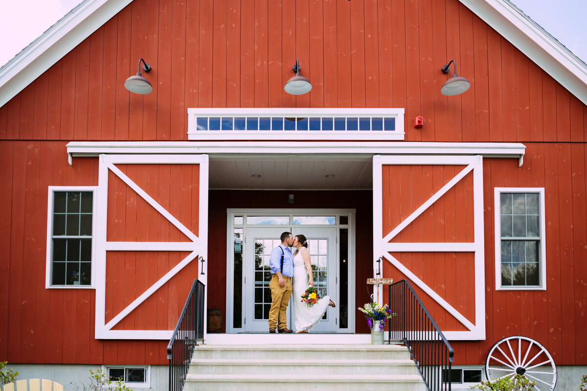 Sterling red barn wedding ceremony with open barn doors