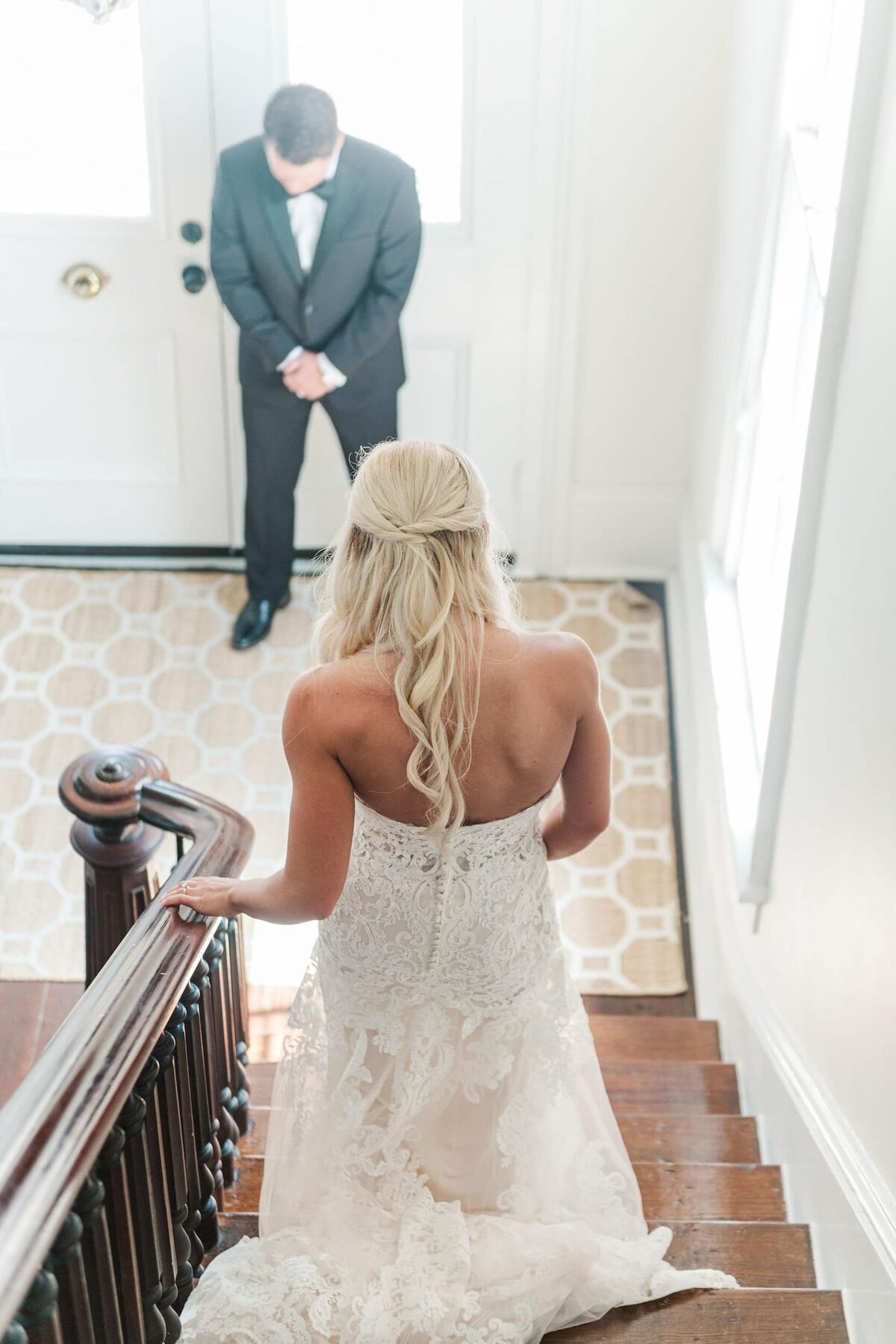 Bride walking down stairs to groom