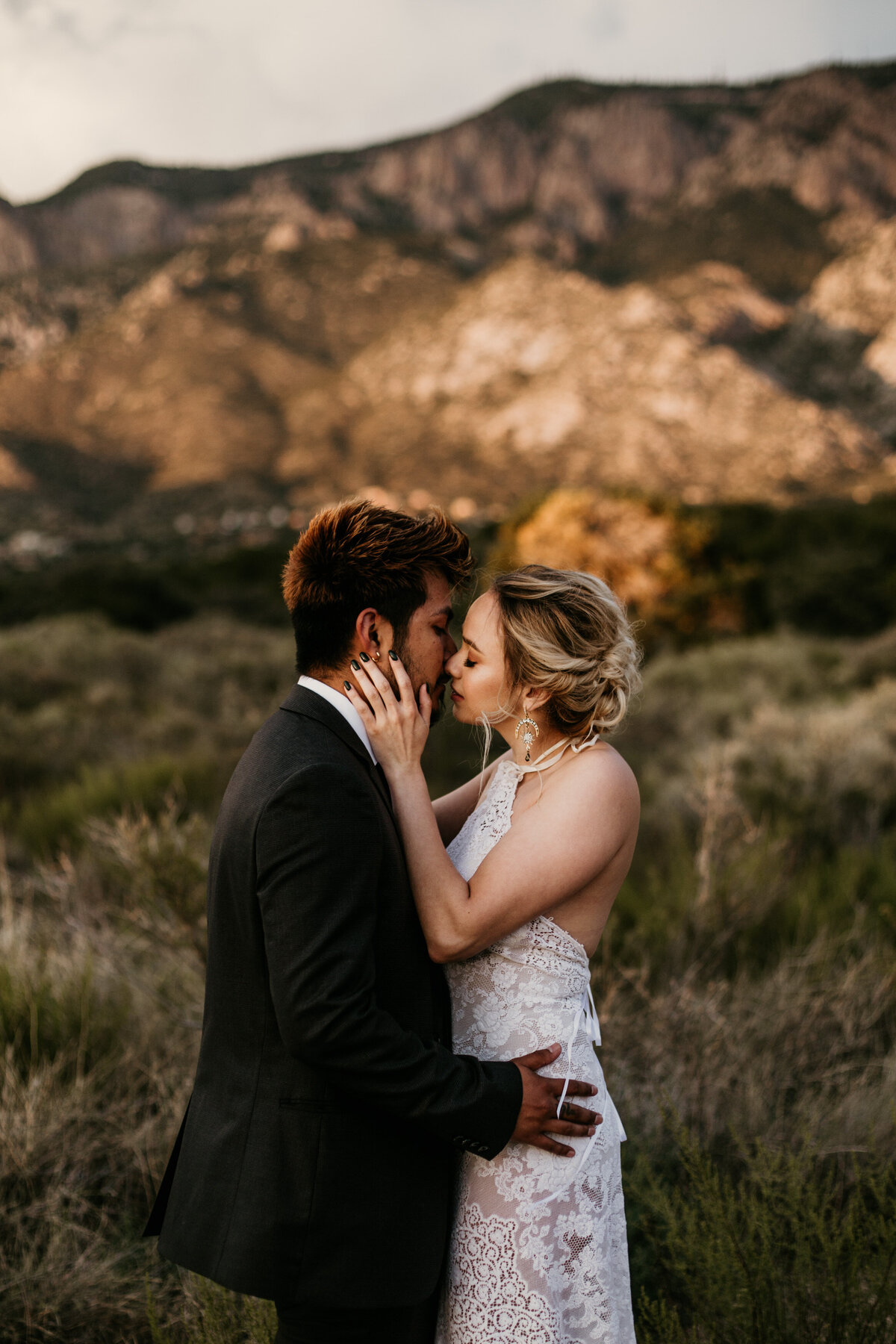 Newlyweds about to kiss in desert