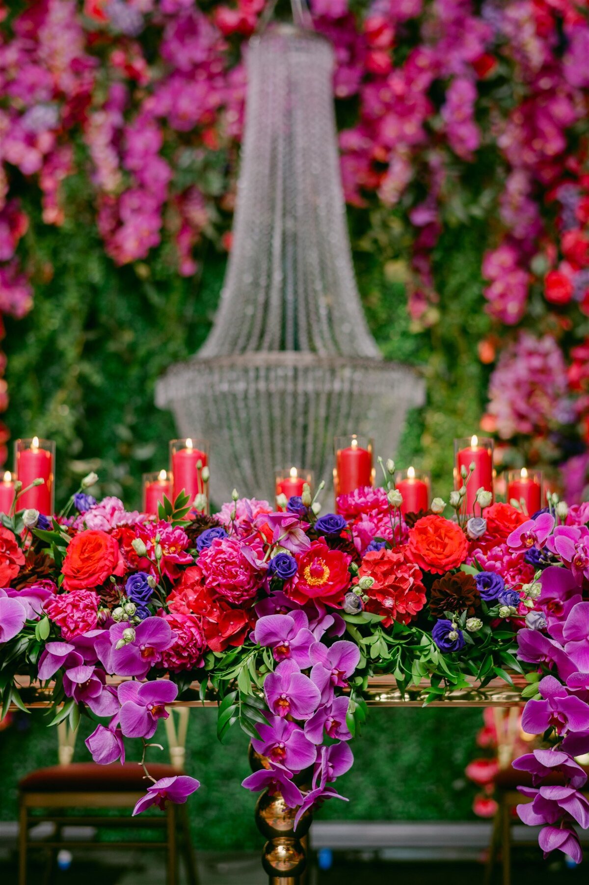 secret-garden-wedding-reception-greenery-pink-purple-gold-chandeliers-orchids