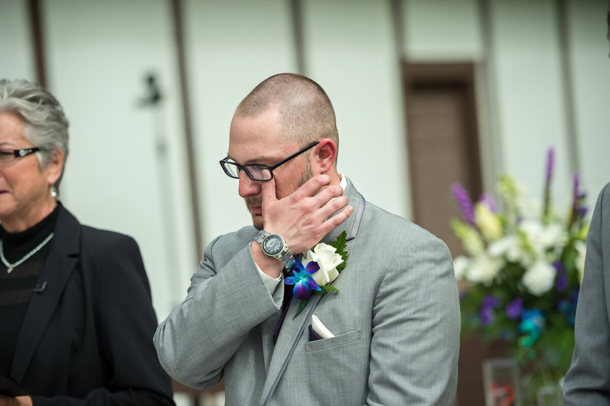 Groom crying when he sees bride.