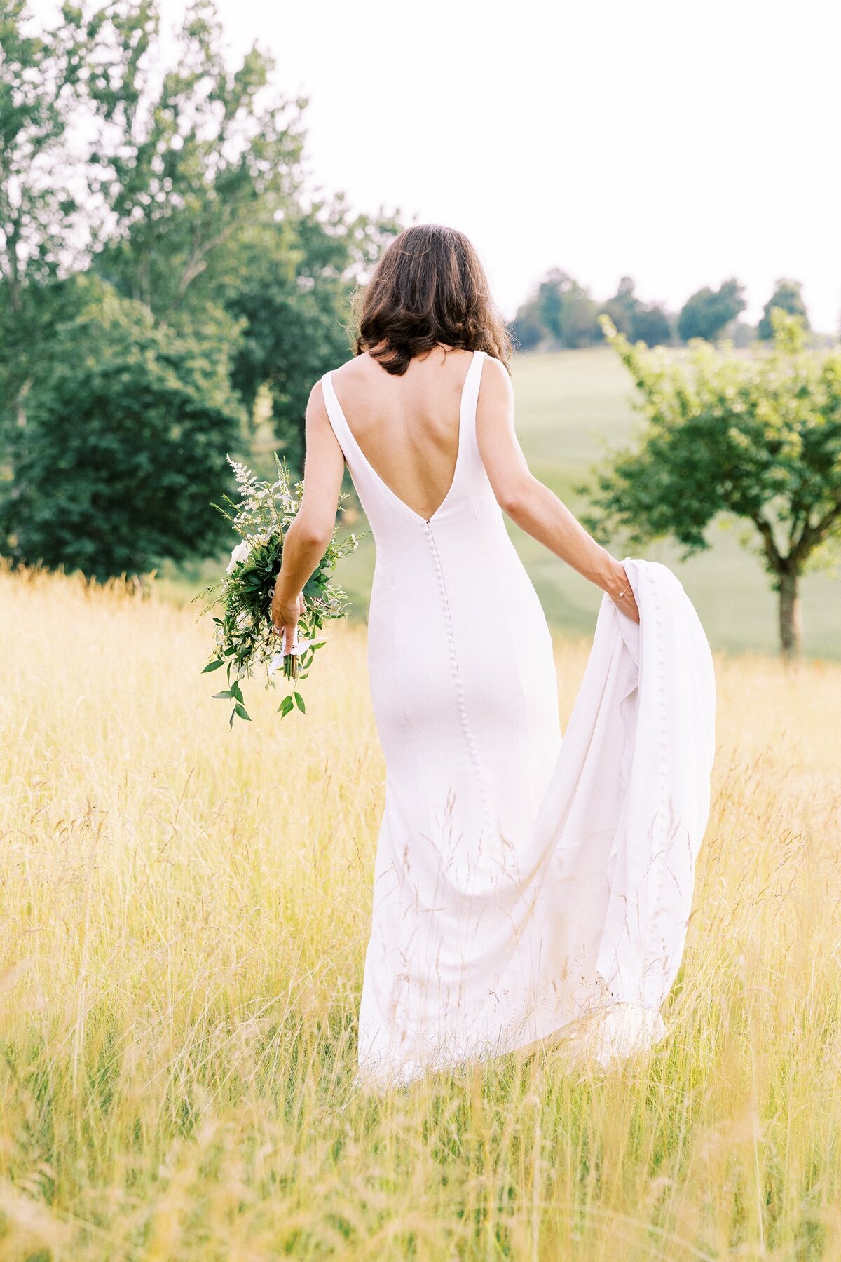 Bride walking in field