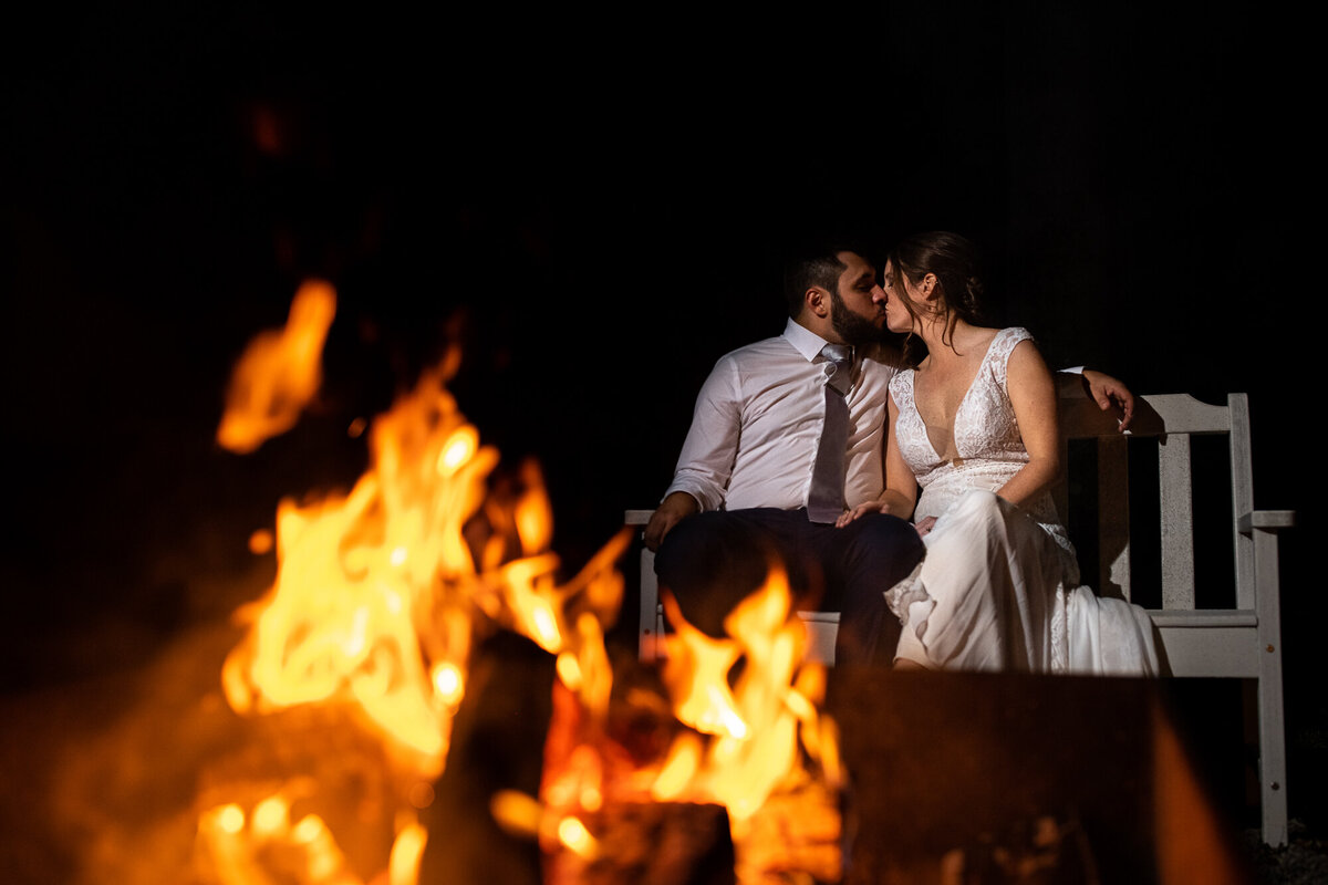 Newlyweds enjoy the fire pit at Oak Grove Wedding Venue