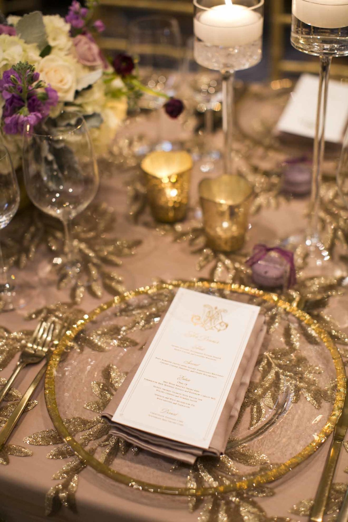 Gold place settings paired beautifully with Purple, and grey floral at this Seattle wedding reception.