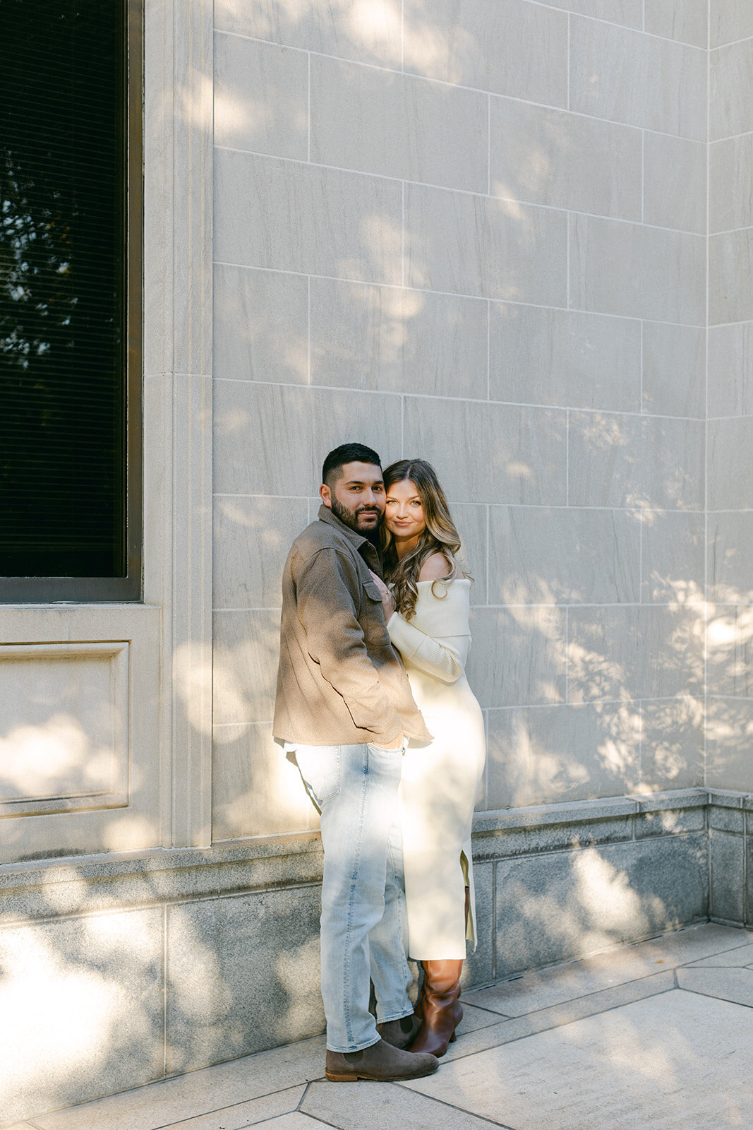 Couple embracing during golden hour engagement session in a Pittsburgh park