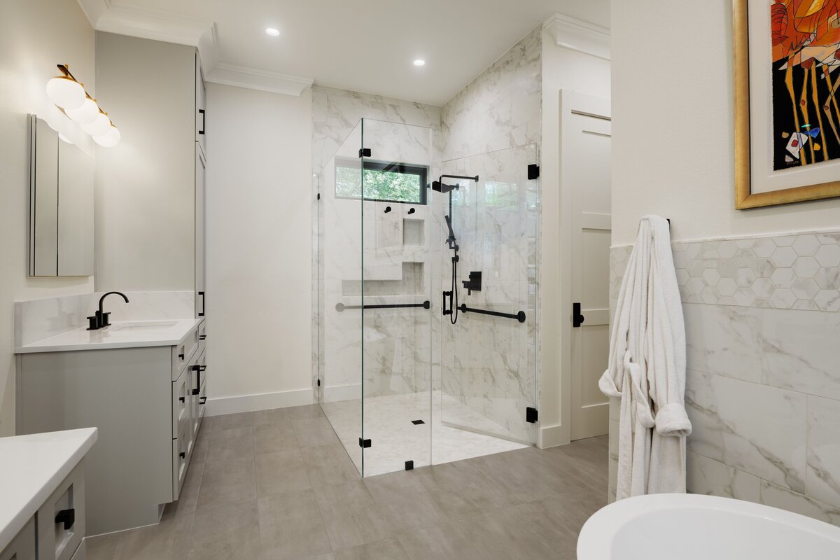 modern white bathroom with glass shower and double sinks