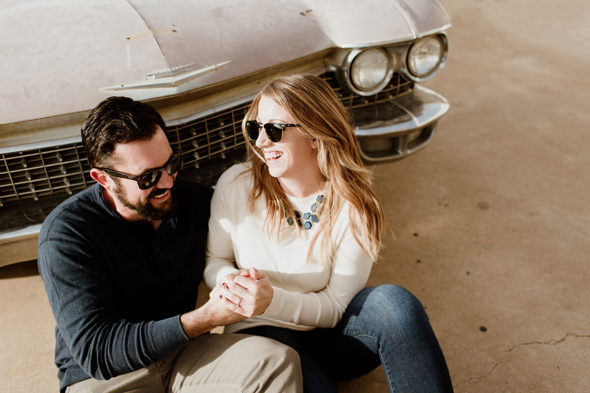 A playful outdoor engagement session with classic cars captured by Fort Worth Wedding Photographer, Megan Christine Studio