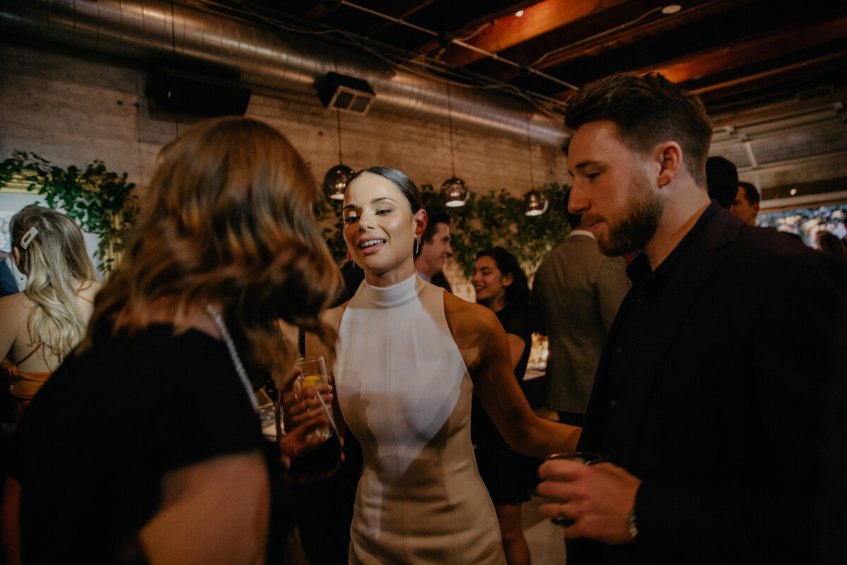 Bride mingles with guests during intimate Chicago wedding at Ada Street restaurant