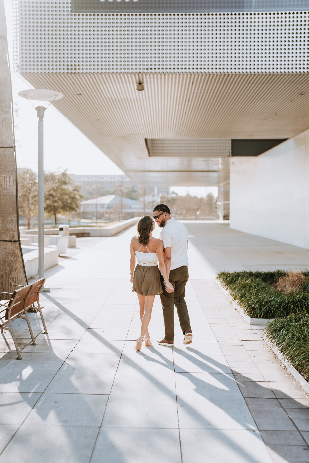 couple walking at the tampa museum of art for engagement photos