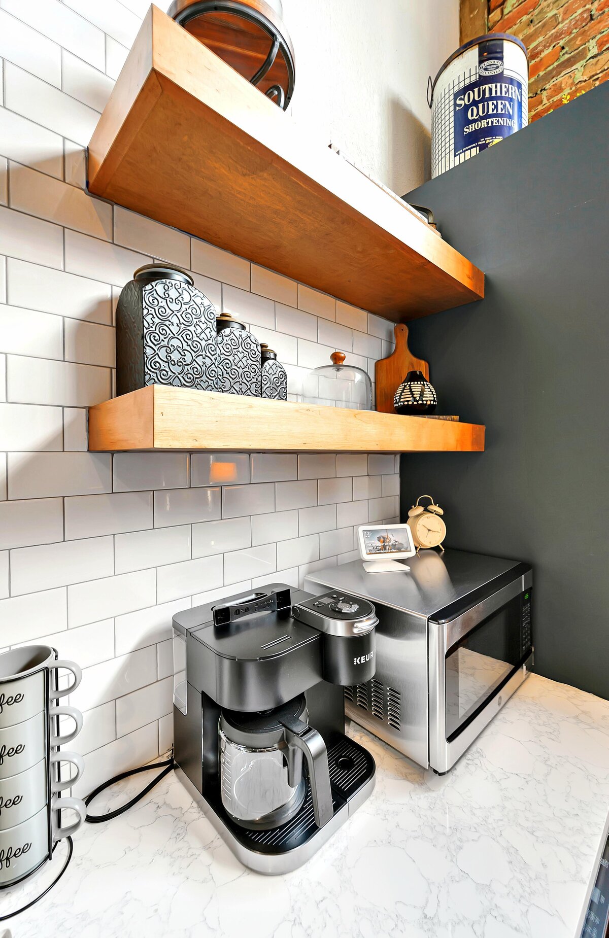 Coffee station includes coffee maker at Keurig with pods and creamer at this two-bedroom, two-bathroom vacation rental condo in the historic Behrens building in the heart of the Magnolia Silo District in downtown Waco, TX.