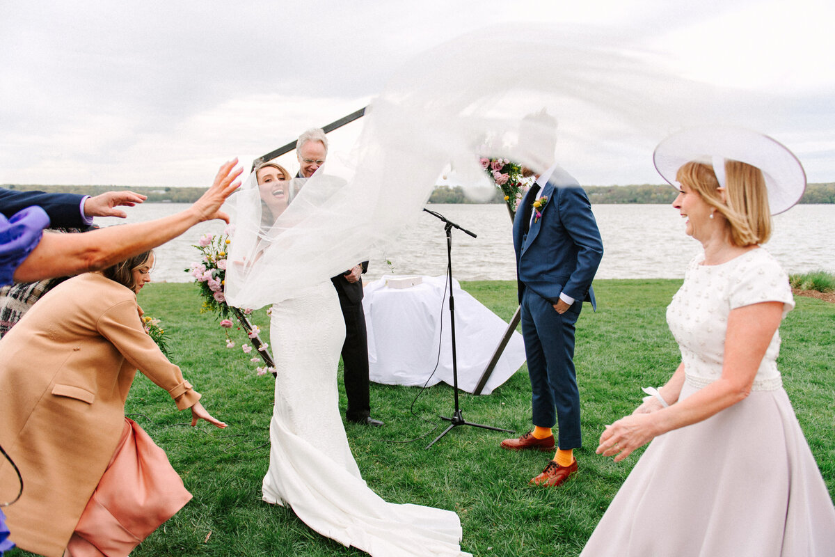 veil flys in the wind during wedding ceremony