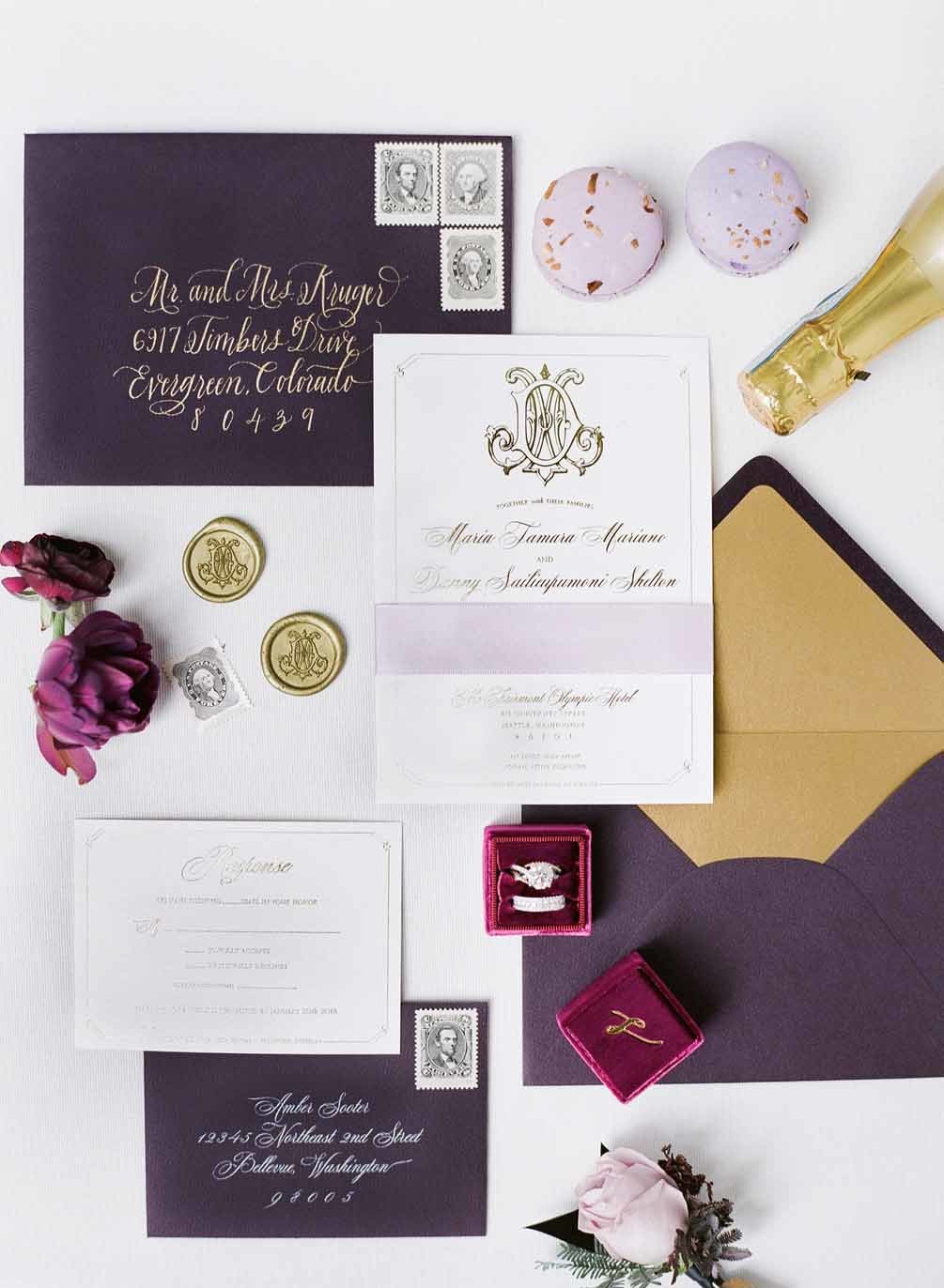 Elegant plum wedding invitation suite styled flat lay