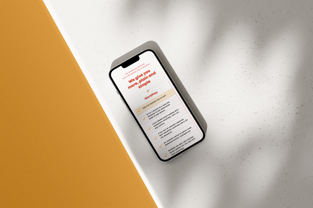 Liberty Type website agency's client website shown on iPhone sitting on white concrete and yellow background