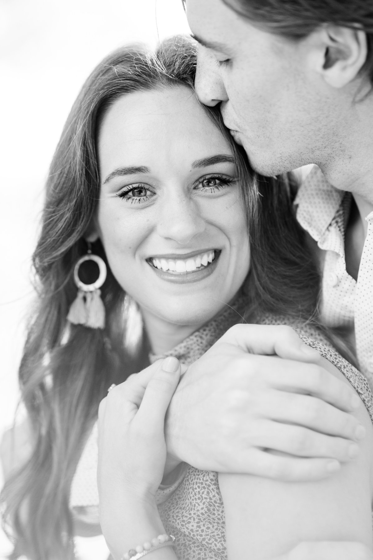 Engagement photo of couple hugging in black and white