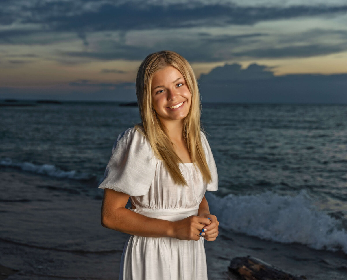 Photo of a high school senior girl at sunset on an Erie Pa beach
