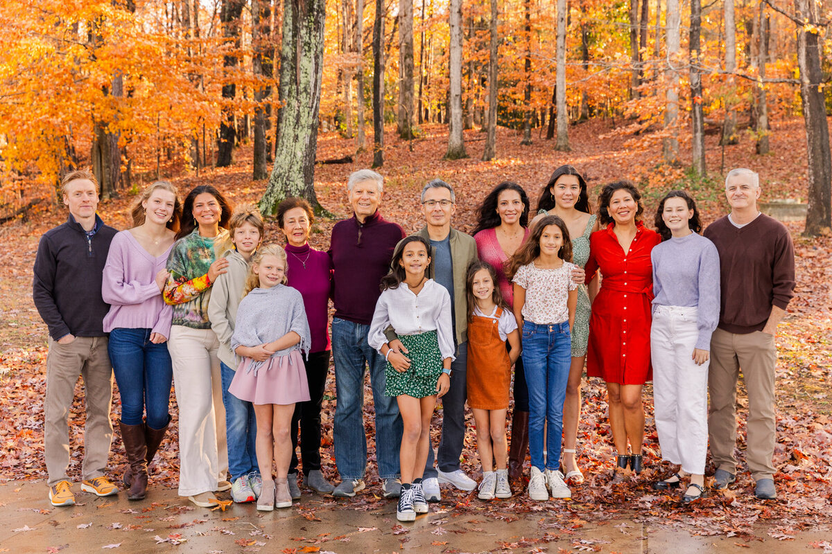 Extended multi generation family during fall photo session on a Brookhaven park path in Atlanta by Laure Photographyn